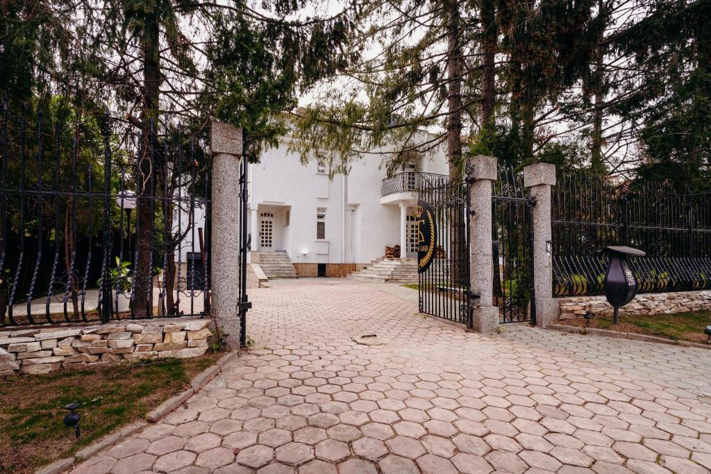 a gate in front of a white house at Knyazheska Banya in Sofia