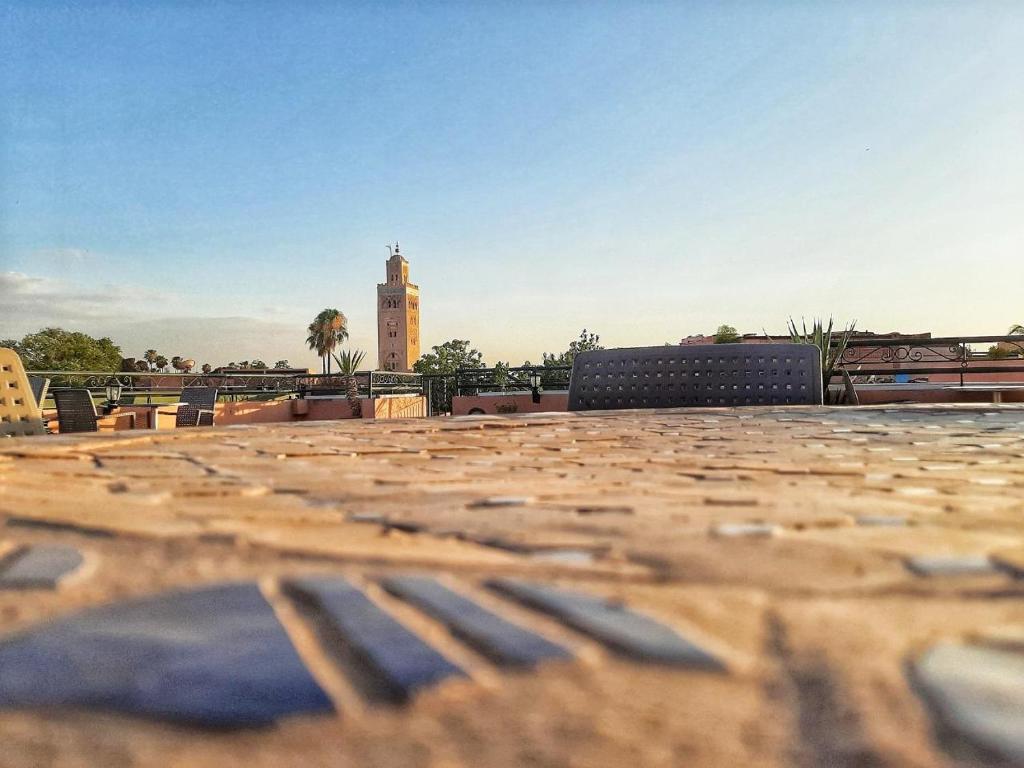 a view of a building with a clock tower in the background at Residence Koutoubienne in Marrakech