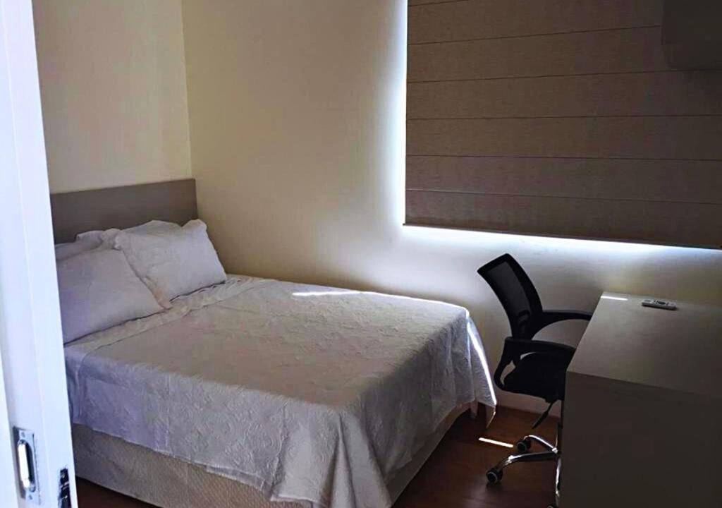 מיטה או מיטות בחדר ב-Gontijo Apart Hotel