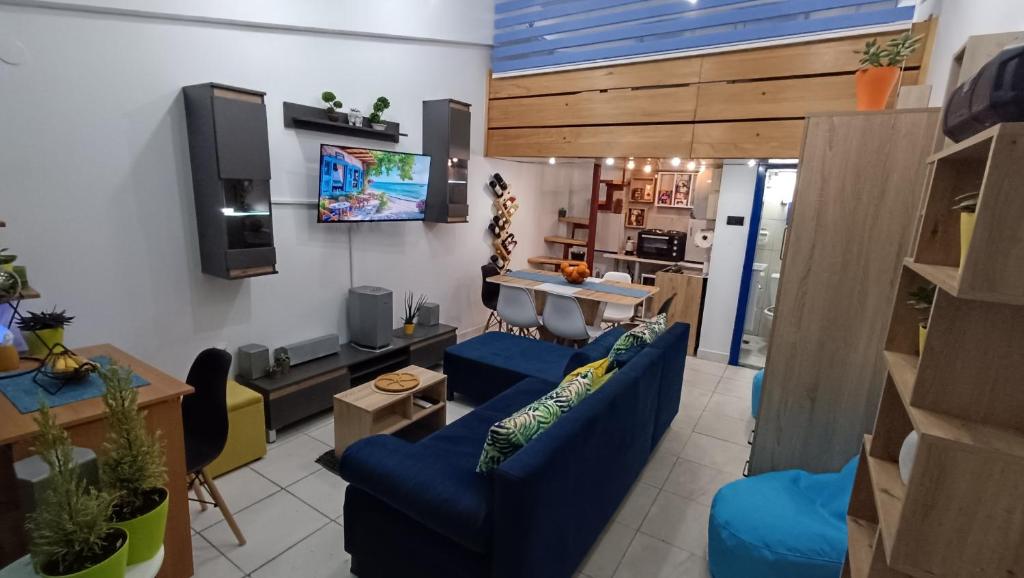 a living room with two blue couches and a kitchen at Nitro Inn 1 Premium Cozy - Wine Tasting - Souvenir - Art Gallery - Private Guided Tours - Relaxing - Romantic in Skopje
