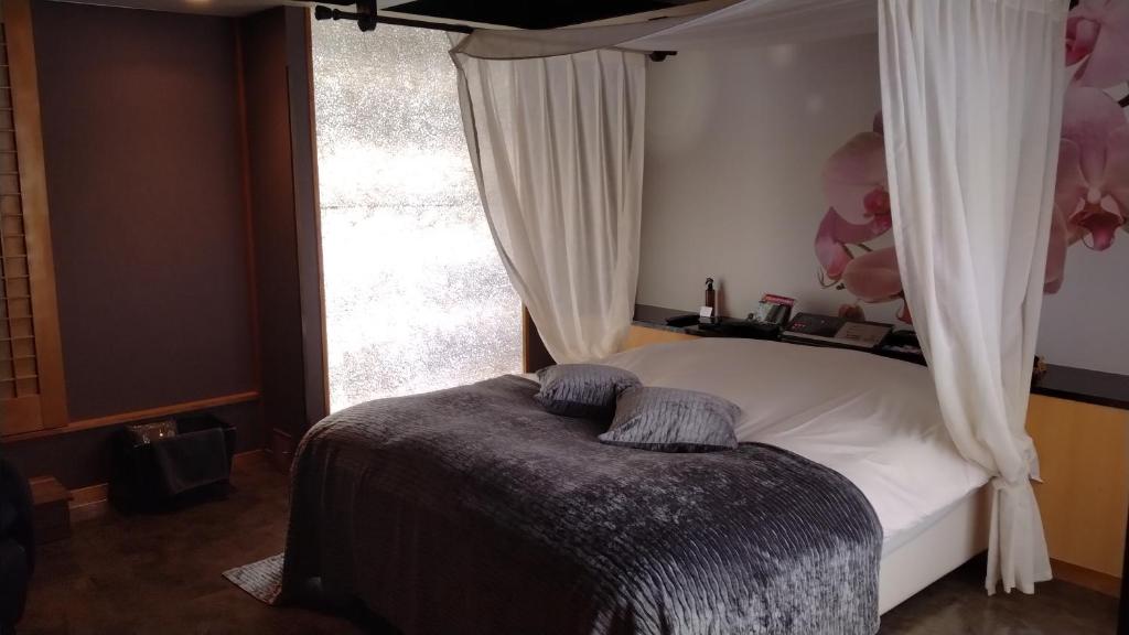 Postel nebo postele na pokoji v ubytování agehA - Adult Only-