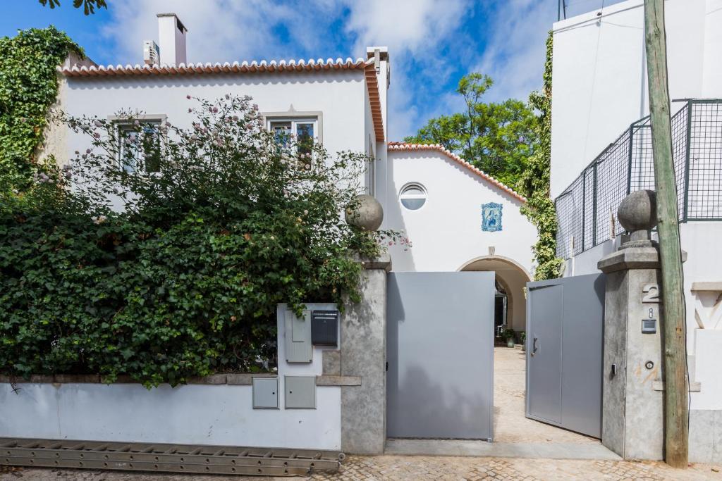 a white house with two refrigerators in front of it at Casa do Museu, Three Independent Properties in Cascais
