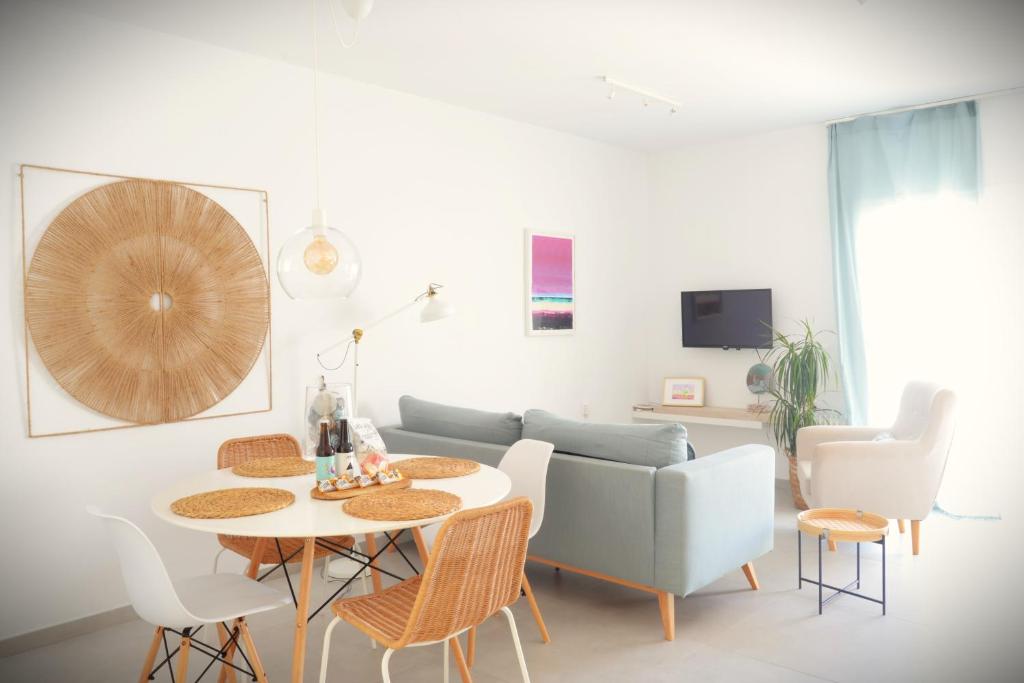 a living room with a table and a couch at CASA MAR GINES NORTE in La Santa