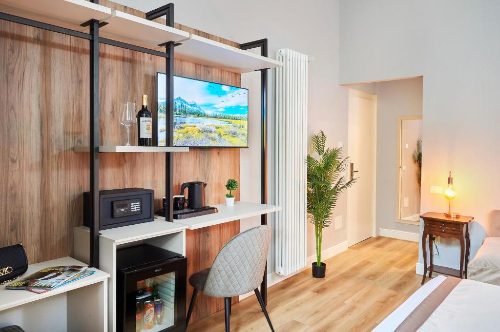 a living room with a bed and a tv at Hotel Lombardi in Florence