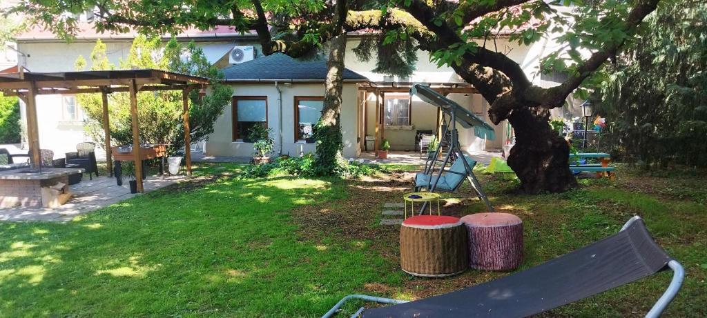 a yard with a bench in front of a house at Rákóczi Guesthouse Miskolc in Miskolc