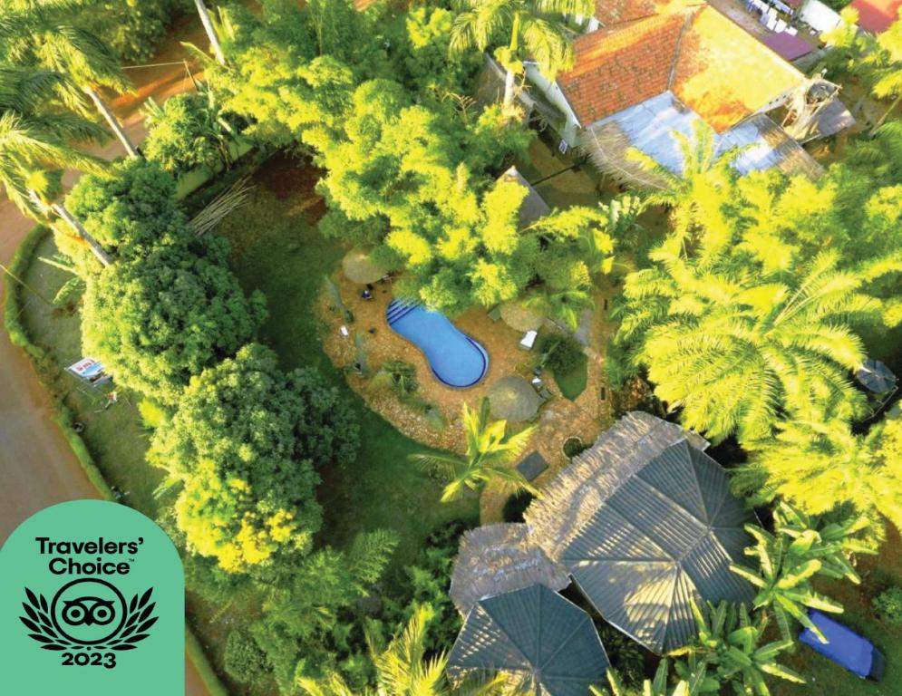 an overhead view of a garden with trees and a house at Afro Smile Hotel and Guest House in Jinja