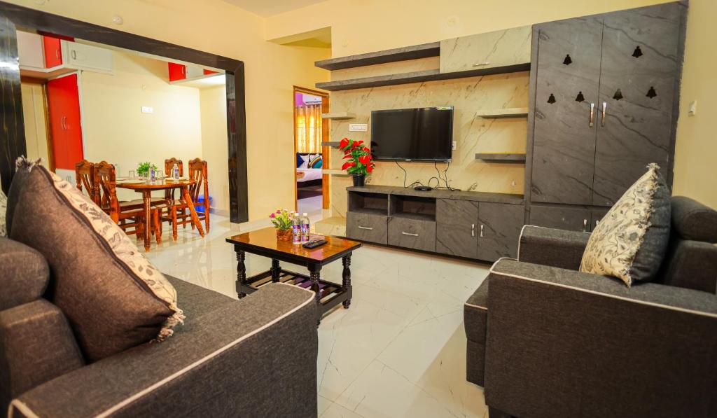 a living room with two couches and a table at S V IDEAL HOMESTAY -2BHK SERVICE APARTMENTS-AC Bedrooms, Premium Amities, Near to Airport in Tirupati