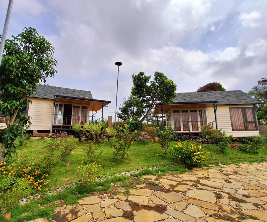 ein Haus mit Garten davor in der Unterkunft Nhà bên hồ sen in Bảo Lộc