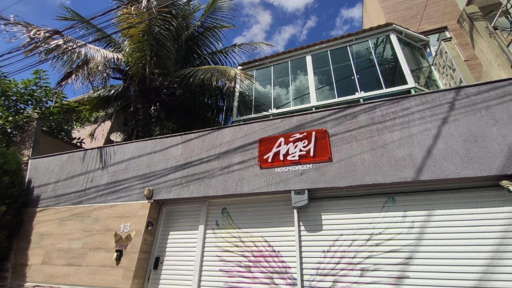 um edifício com uma placa no topo em Angel Hospedagem de quartos em Vila Velha