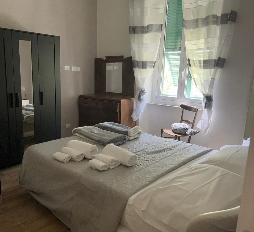a bedroom with a large bed with towels on it at Villa delle mimose in Sestri Levante