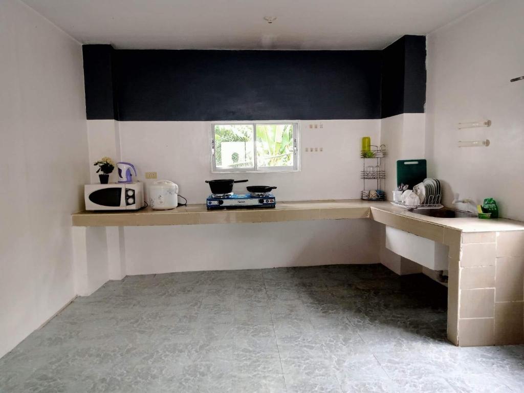 a kitchen with a counter top and a microwave at Diniwid Garden Beach in Boracay