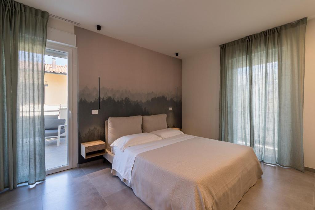 Łóżko lub łóżka w pokoju w obiekcie Residence Stella