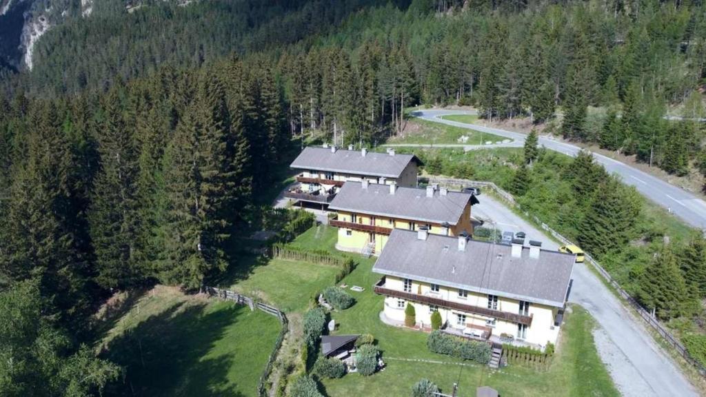 - une vue aérienne sur une grande maison dans les montagnes dans l'établissement Ferienwohnung Schweizer Sennenhund, à Nauders