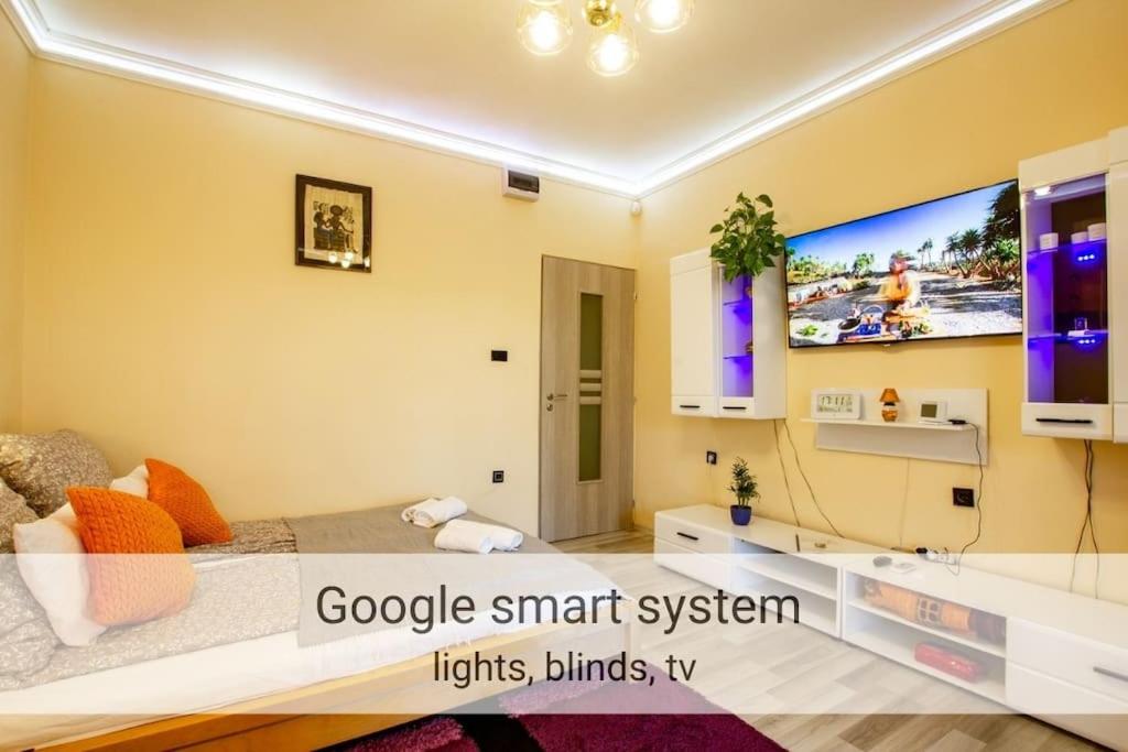 a bedroom with a bed and a tv on the wall at Outdoor Adventure Smart Riverside Pet Friendly in Budapest