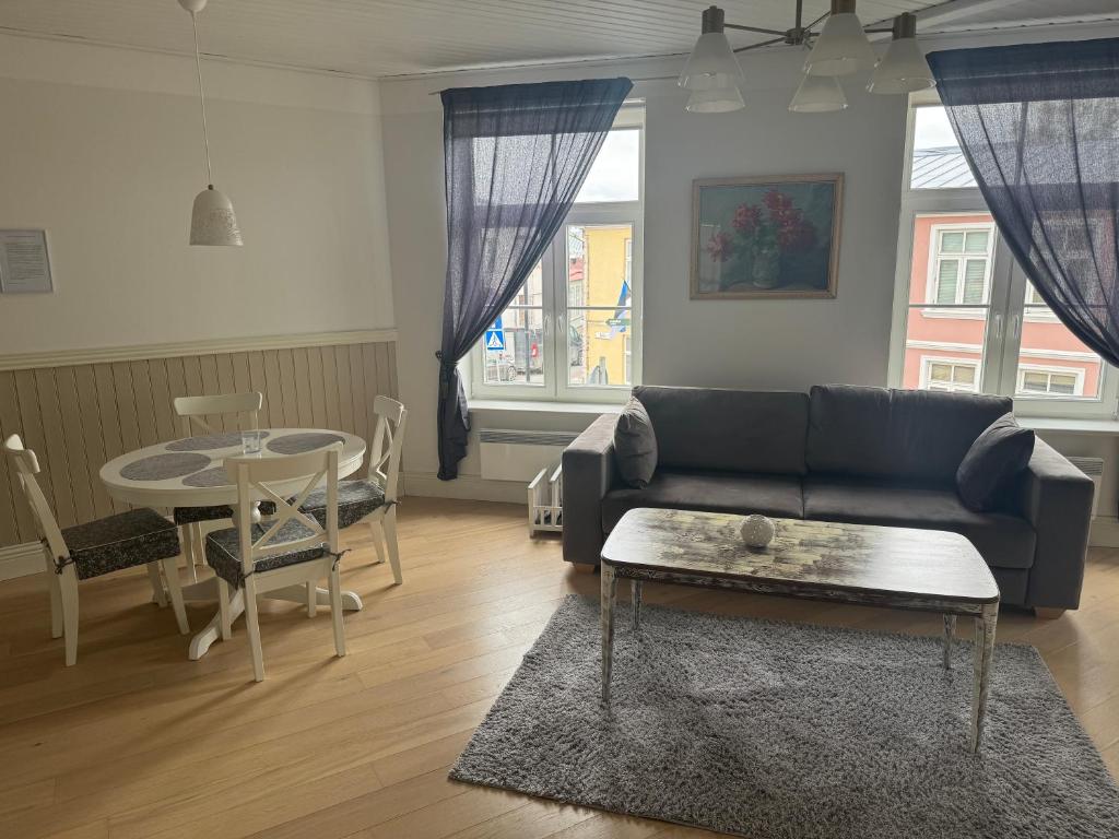 a living room with a couch and a table at Karja Apartment with sauna in Haapsalu