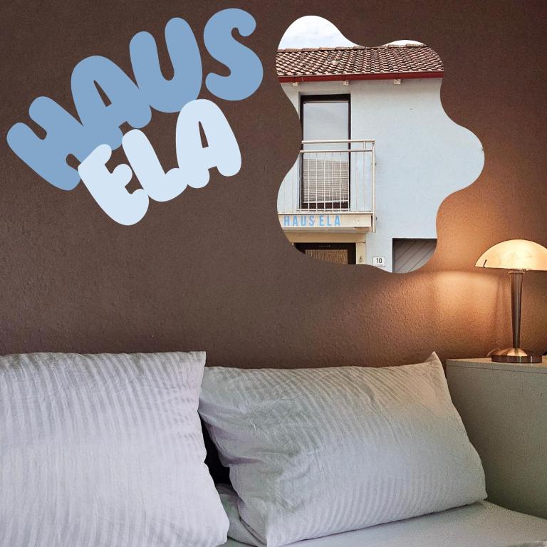 a bedroom with a bed with a sign on the wall at Haus Ela in Sächsenheim