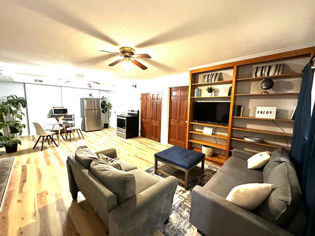 a living room with a couch and a ceiling fan at Private 1BR Mins to Downtown, Serene Backyard in Gastonia