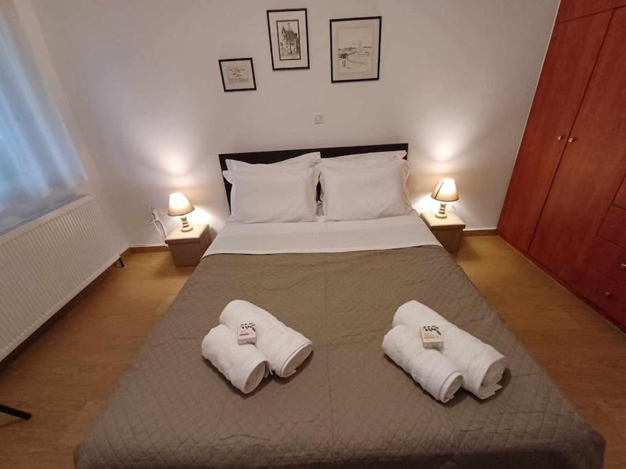 a bedroom with a bed with two towels on it at Anatoli apartment in Mytilene