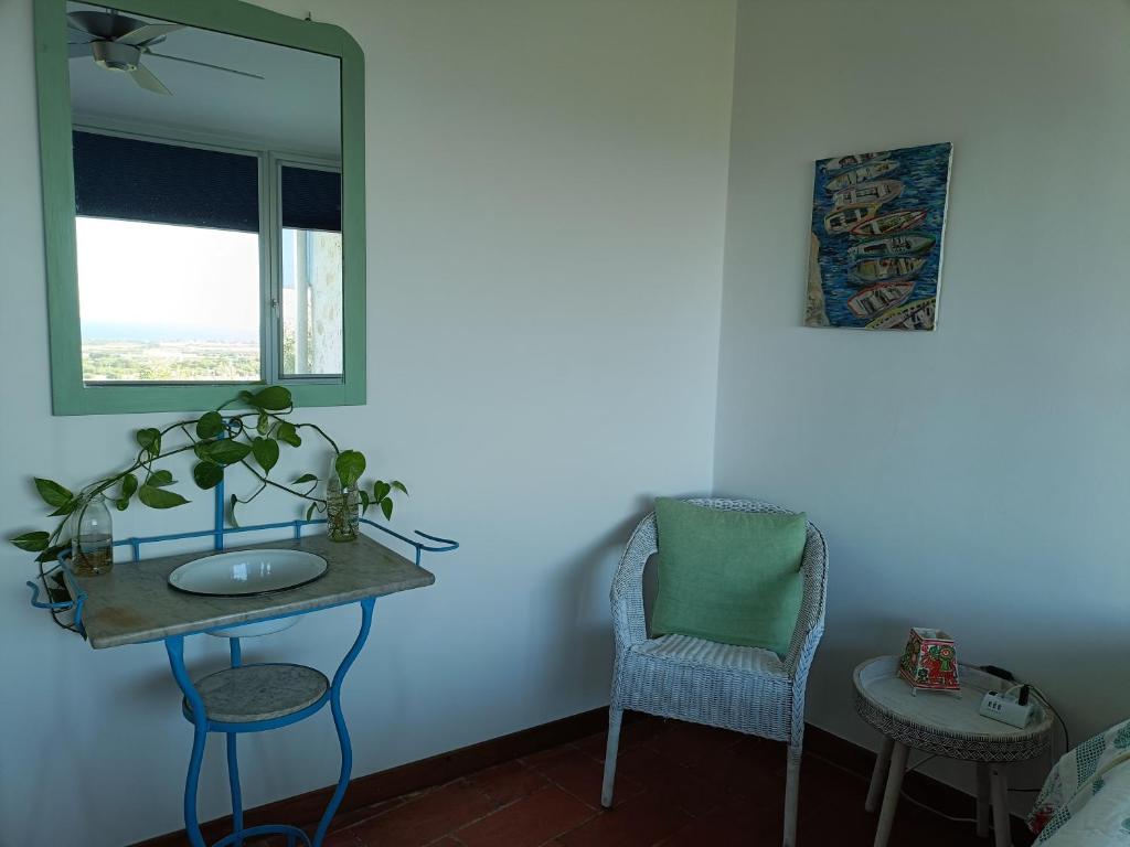 a bathroom with a sink and a mirror and a chair at le finestre sul mare in Conversano