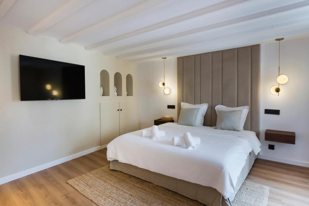 - une chambre avec un grand lit blanc et une télévision à écran plat dans l'établissement Luxury suite Forville - Cannes center, à Cannes