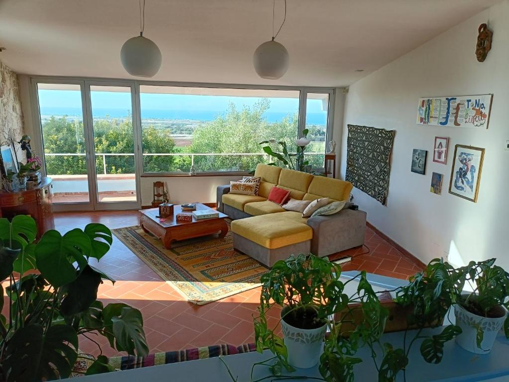 a living room with a couch and a large window at le finestre sul mare in Conversano