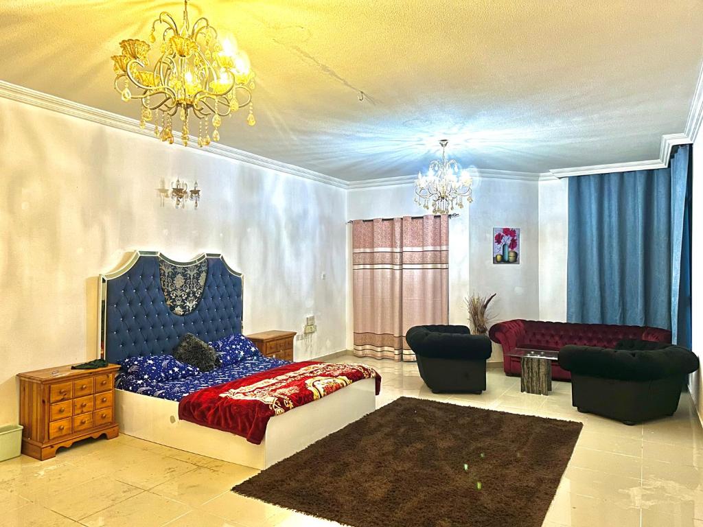 a bedroom with a bed and a living room at Tranquil Haven King Bed Ensuite Fully Furnished Bedroom in Ajman 