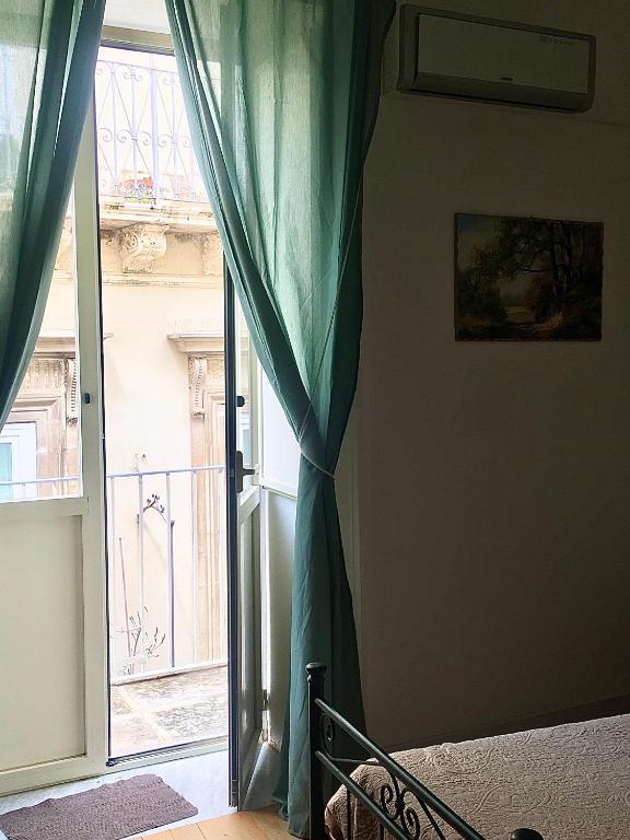 Postel nebo postele na pokoji v ubytování B&B Domus Gaetani
