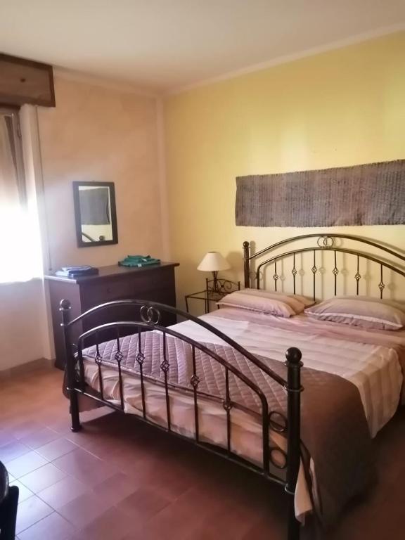 a bedroom with a large bed in a room at Sa Mendula in Bonorva