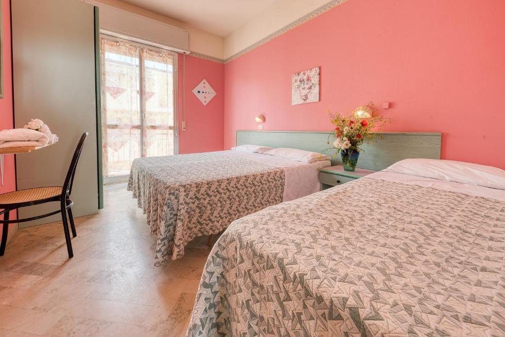 Postel nebo postele na pokoji v ubytování Hotel Sabbia d'Oro