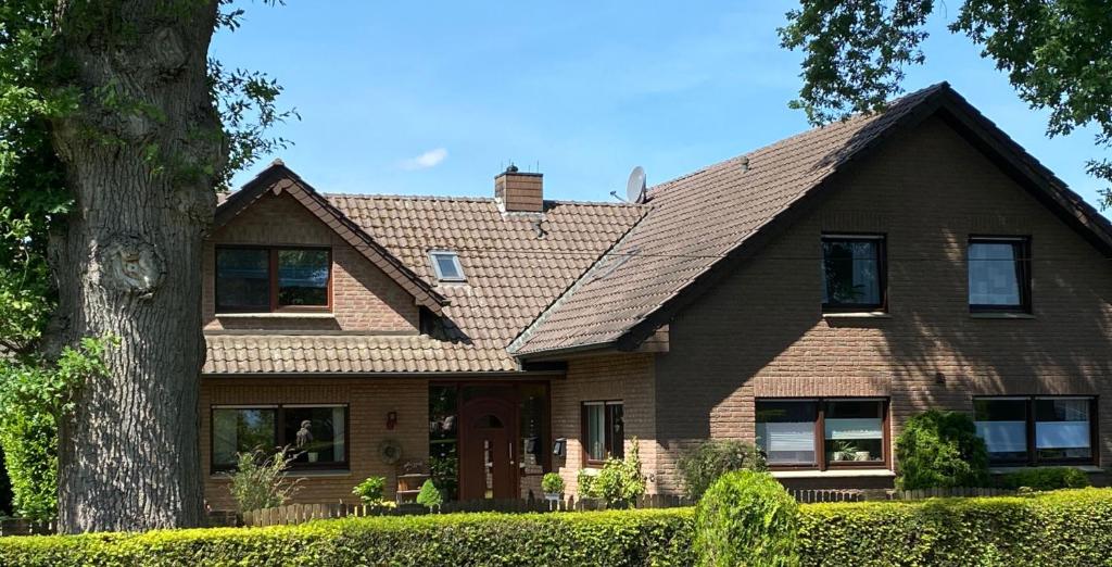 a brown house with a tree at Naturpunkt in Isselburg-Anholt in Isselburg