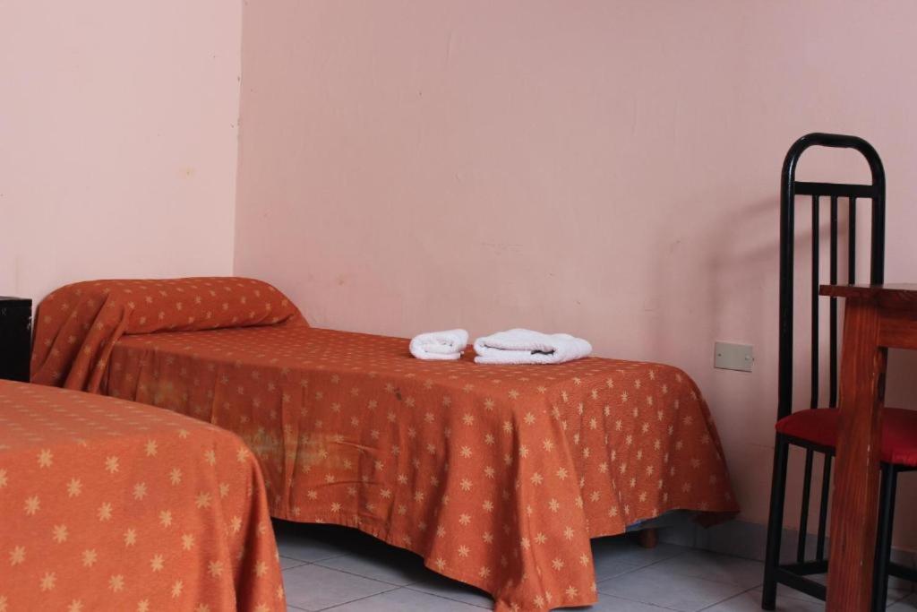 Una cama o camas en una habitación de Hotel Piamonte