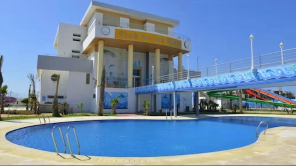 a large swimming pool in front of a building at Asilah Marina Golf Sea Ocean and Golf view in Asilah