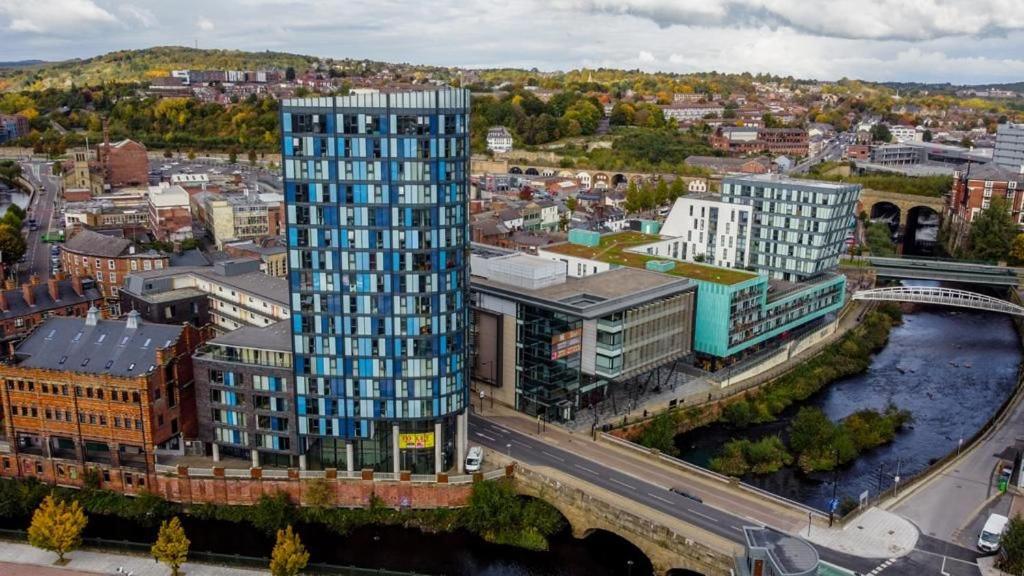 an overhead view of a city with a tall building at Stay Yorkshire City Centre Apartments in Sheffield