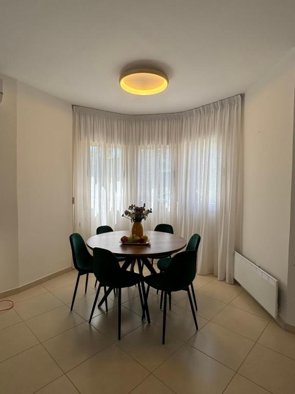 a dining room with a table and chairs at Paez Villa in Protaras