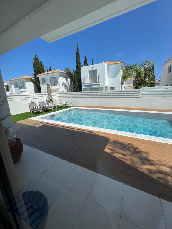 a swimming pool in front of a villa at Paez Villa in Protaras