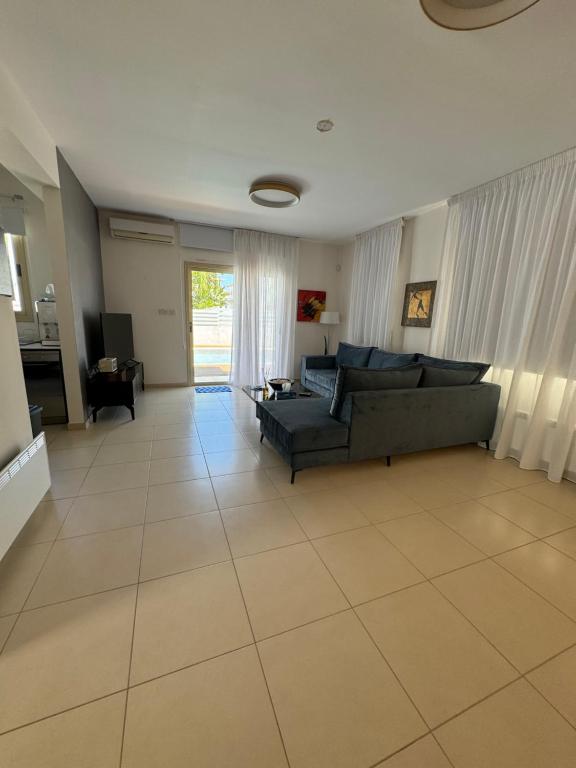 a living room with a couch and a table at Paez Villa in Protaras