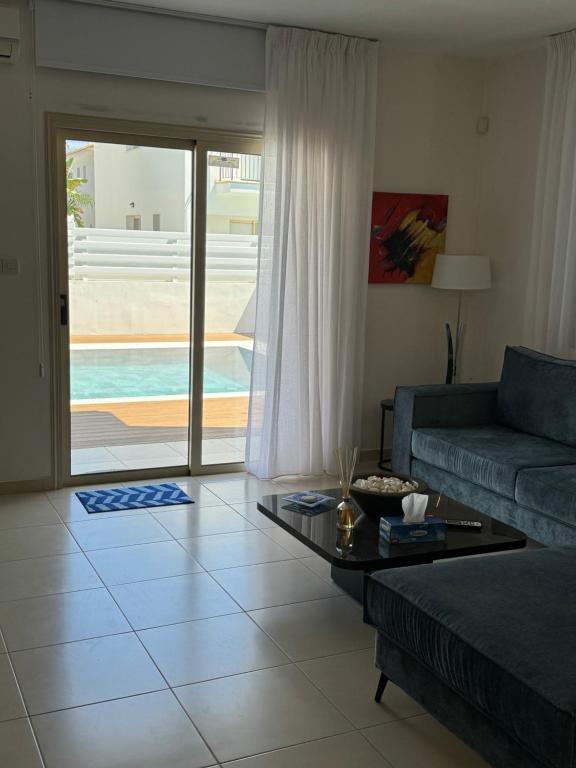 a living room with a couch and a table at Paez Villa in Protaras