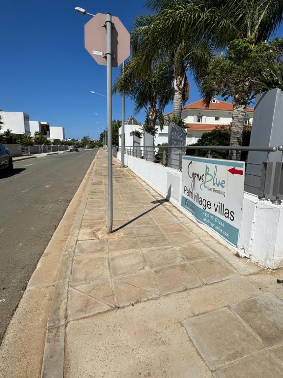 a pole on a sidewalk next to a street at Paez Villa in Protaras