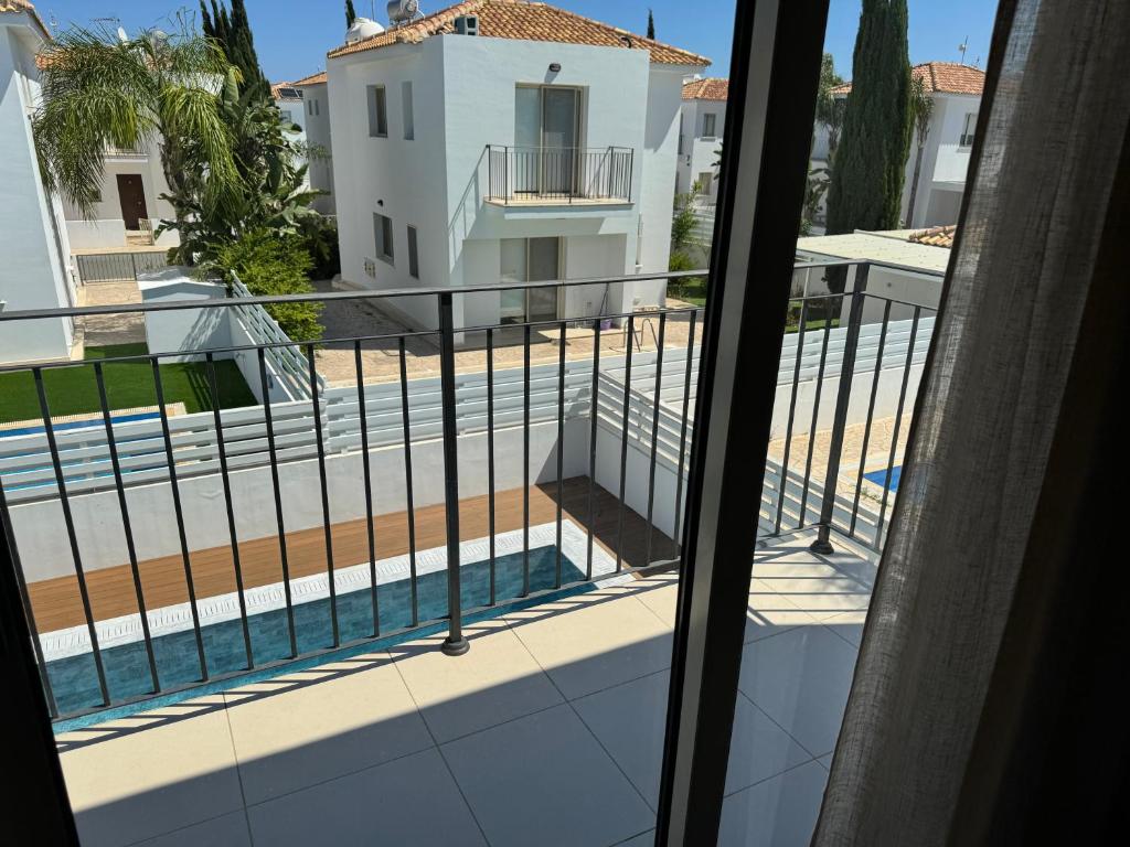 a balcony with a view of a swimming pool at Paez Villa in Protaras