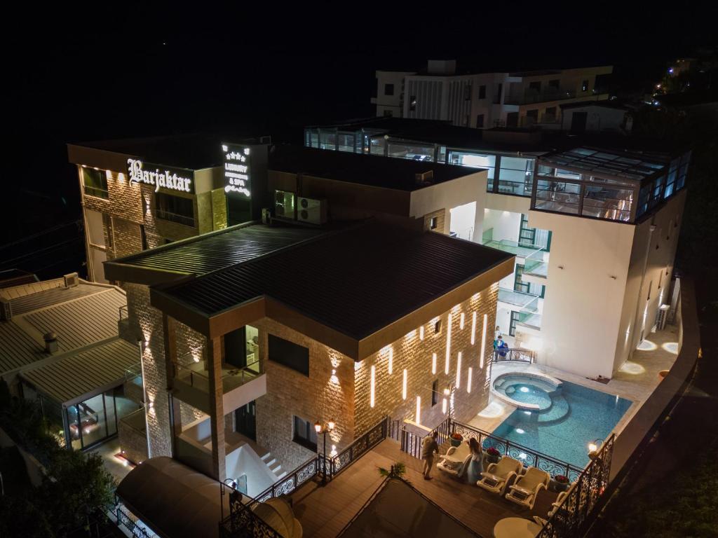 an aerial view of a building with a swimming pool at night at Barjaktar - Luxury Suites & SPA in Ulcinj
