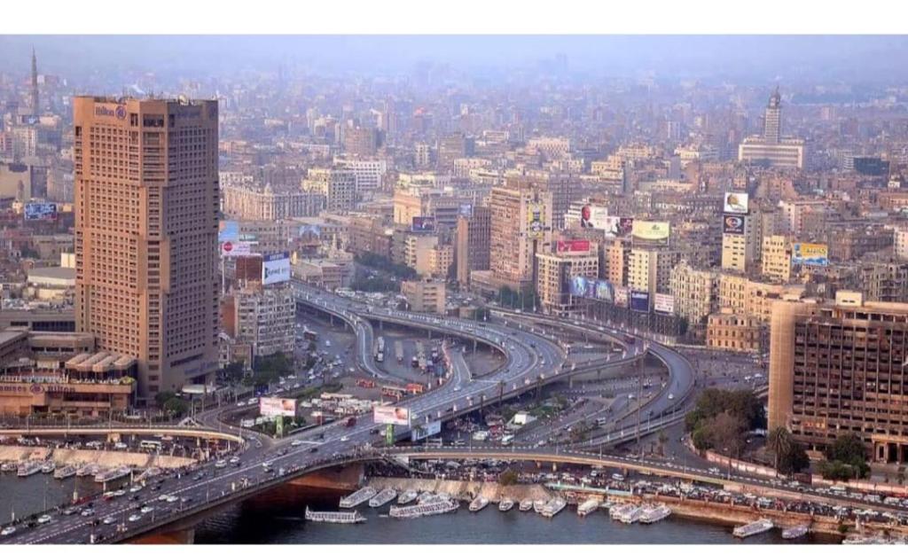 a large city with a busy highway and buildings at Mina Alsalam Hotel فندق ميناء السلام in Cairo
