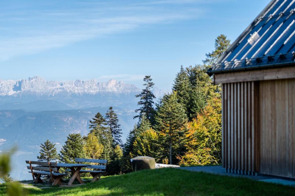a picnic table and a bench on a hill with a view at NEW OPENING "Sissi Chalets" - Unique Luxury Hideaway with Mountain view & Sauna in Mendola