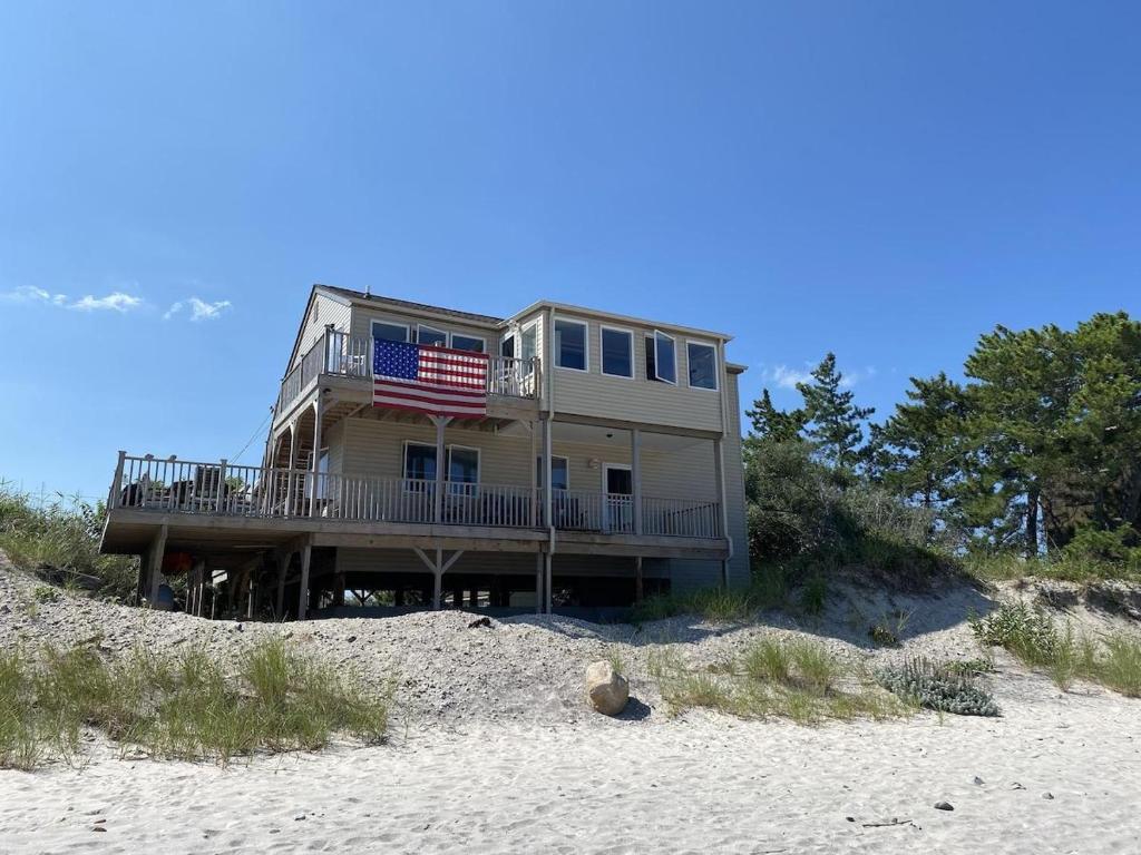 a house on the beach with an american flag at Poppys Private Beach Paradise: Wading River, Northfork in Wading River