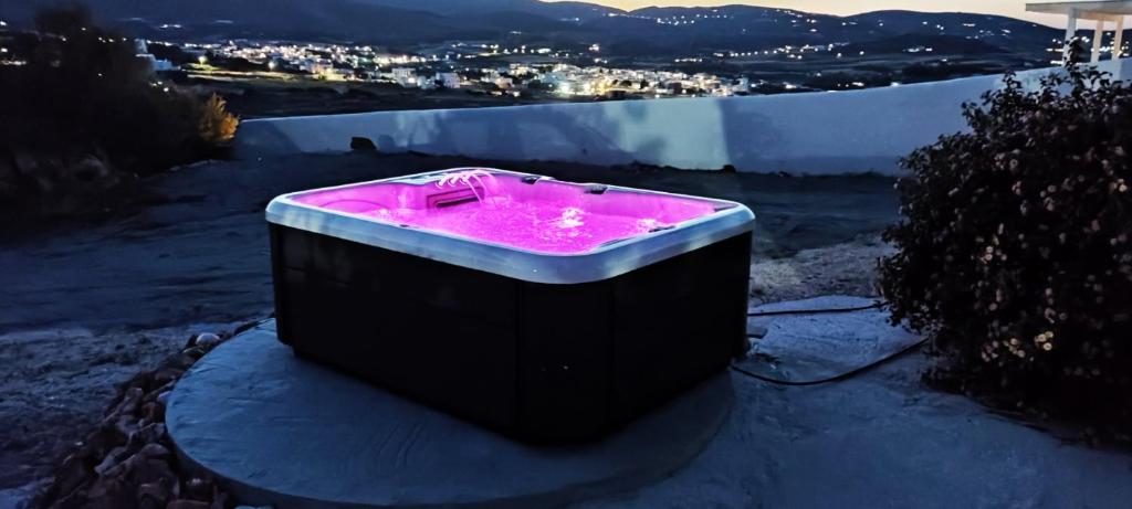 a hot tub sitting on the side of a hill at Olympio Luxury Studio Paros in Kampos Paros