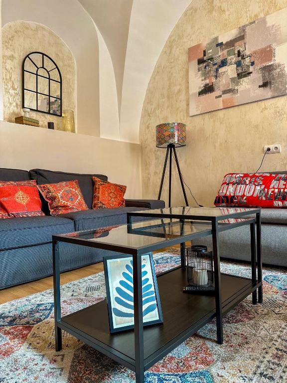 a living room with a couch and a table at Serenity House Apartments in Sibiu