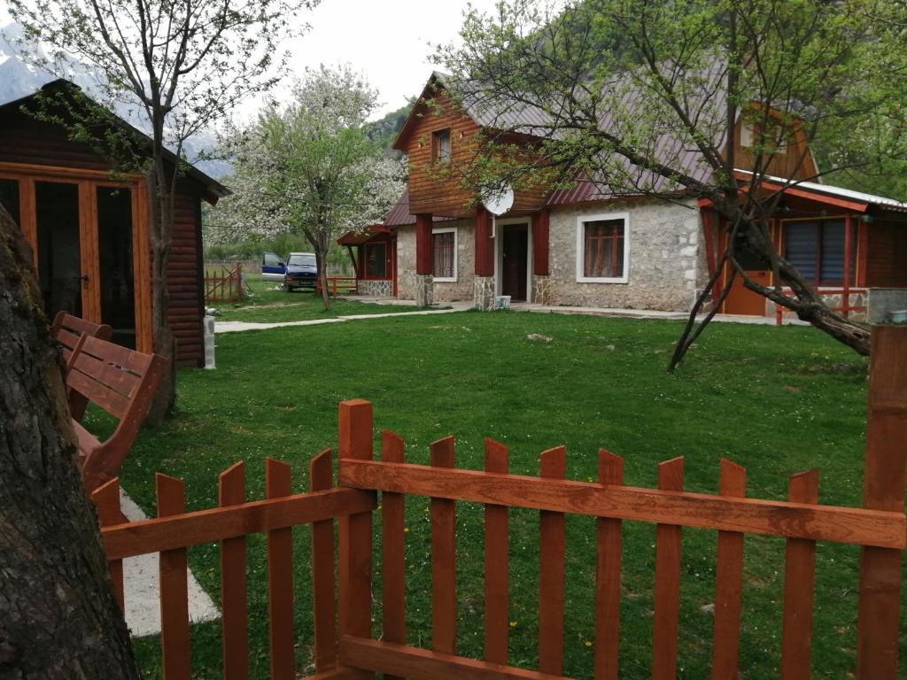 a wooden fence in front of a house at Bujtina Pllumi Theth in Theth