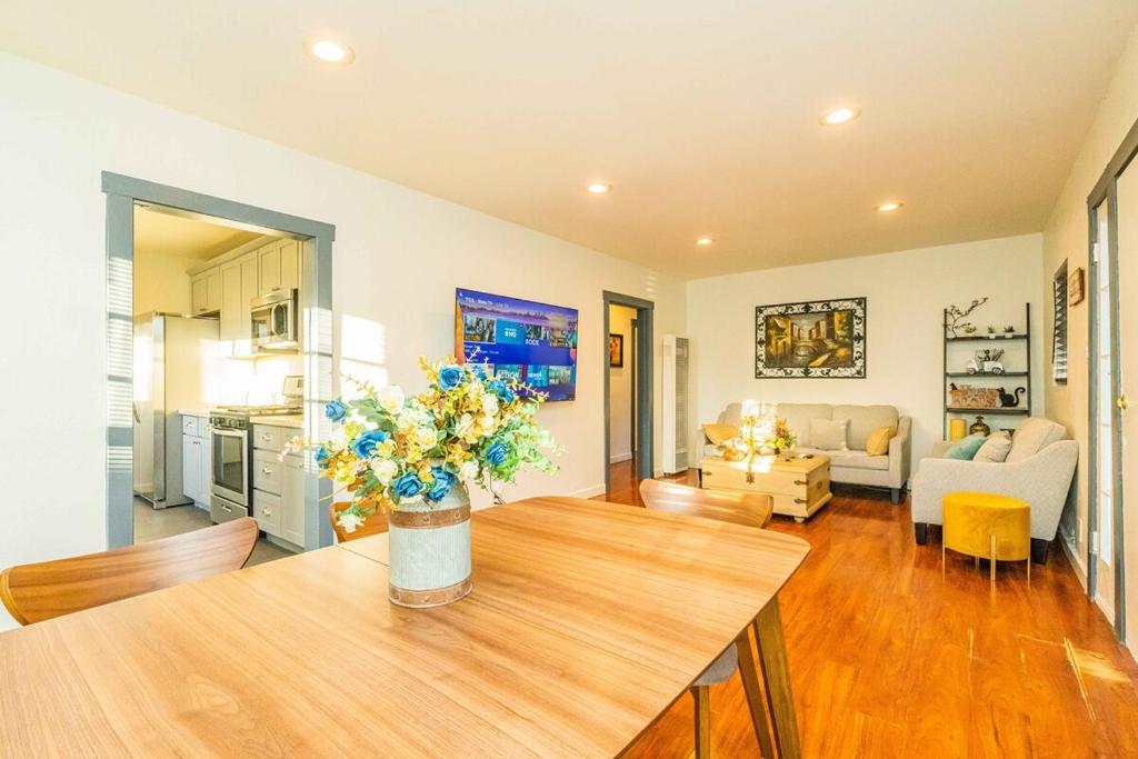 a living room with a table with flowers on it at Newly Remodeled 3B2B House in Glendora