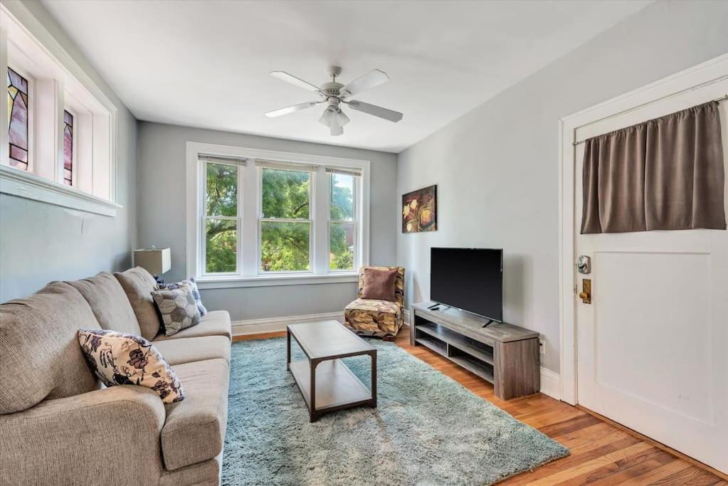 a living room with a couch and a tv at 2e Tower Grove Getaway in Richmond Heights