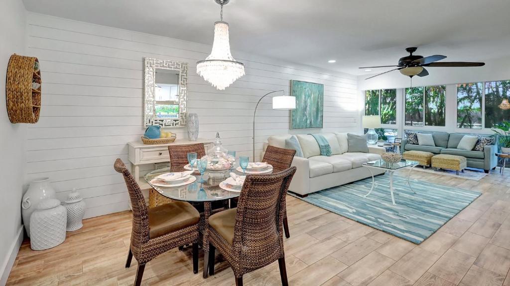 a living room with a table and chairs and a couch at 1166 PD Contemporary Coastal Luxury in Siesta Key