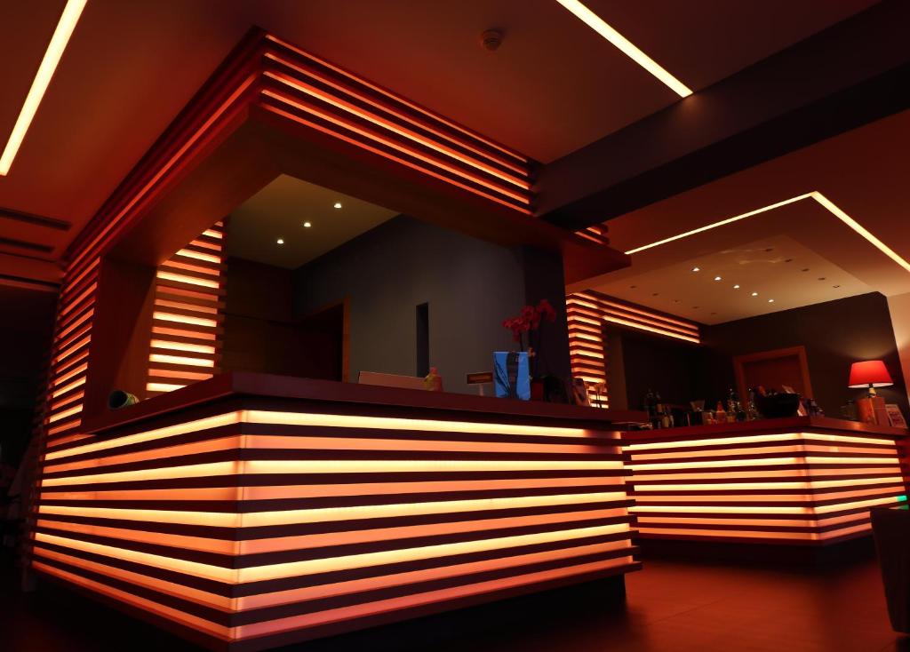 a bar in a restaurant with lights on it at Eco Hotel Cleofe in Caorle